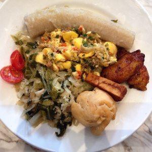 Jamaican breakfast with ackee and saltfish, fried dumpling, boiled banana, callaloo