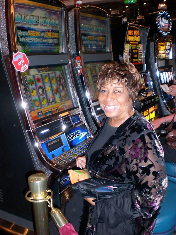 Mom trying her luck on slot machines on a cruise ship!