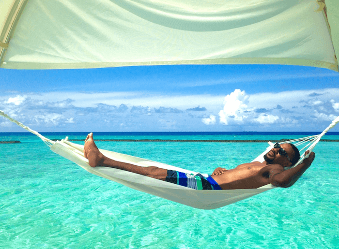 man in hammock over ocean