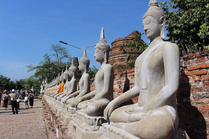 row of stone Buddhas