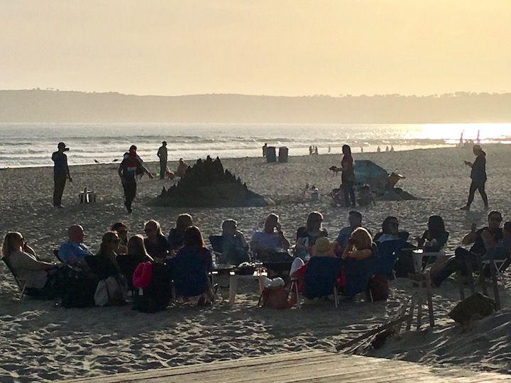 people around bonfires on the beach at Coronado Island