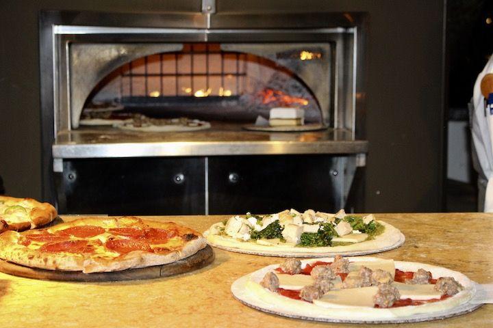 Specialty wood fired pizzas in front of the oven at Eno
