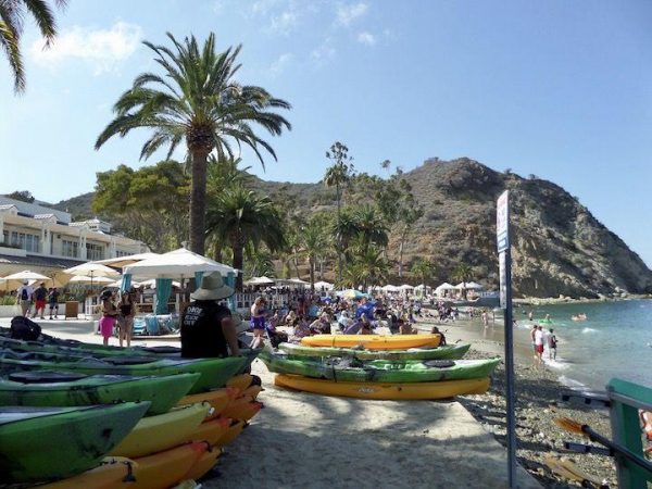 stacks of kayaks on the beach