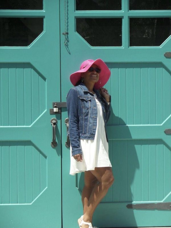 woman in front of teal door