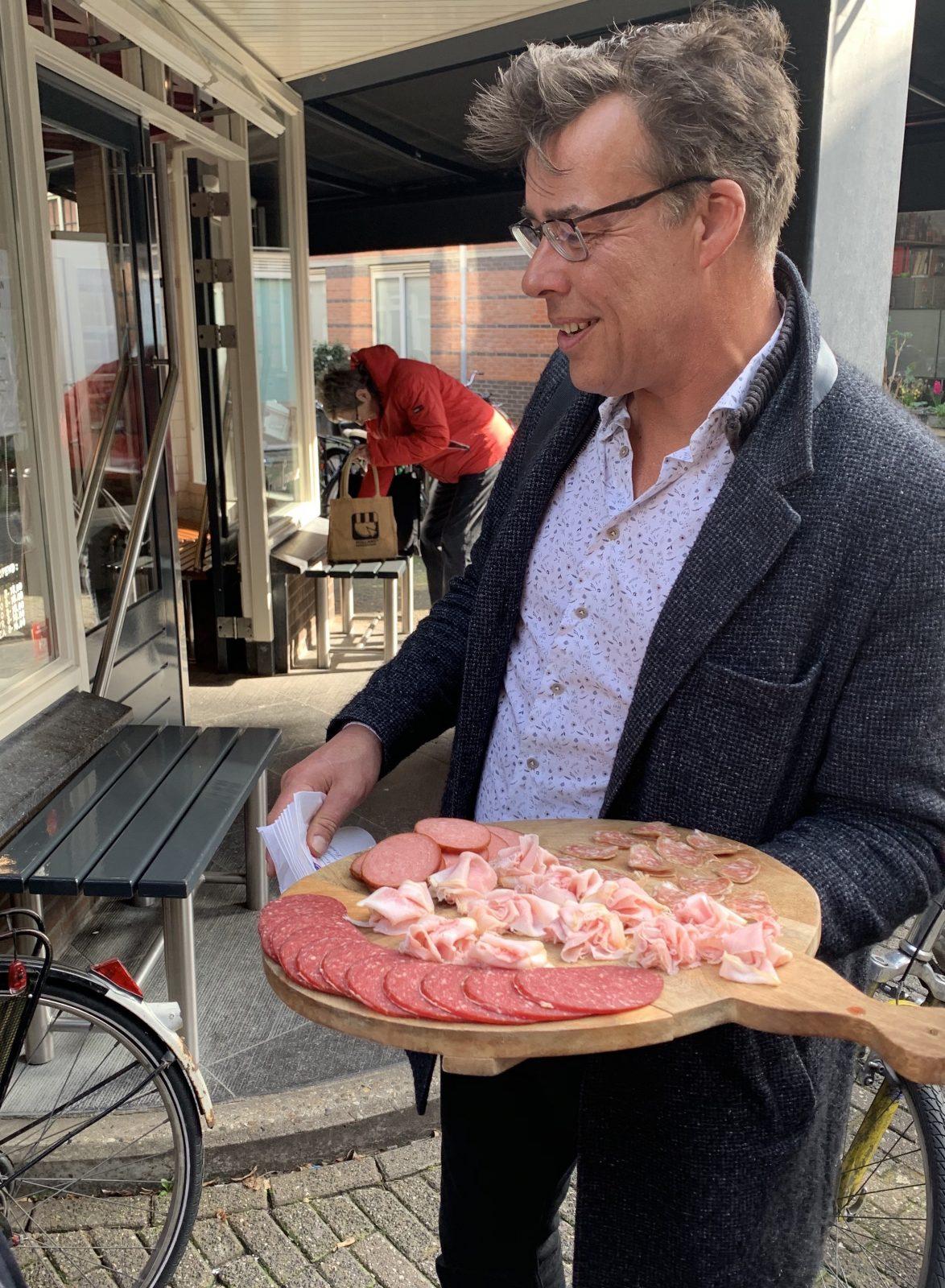 walking food tour guide with charcuterie plate