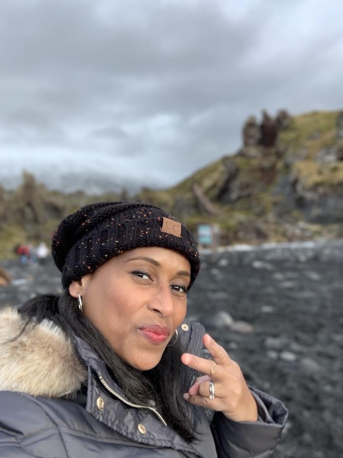 the author standing in front of the water in Iceland