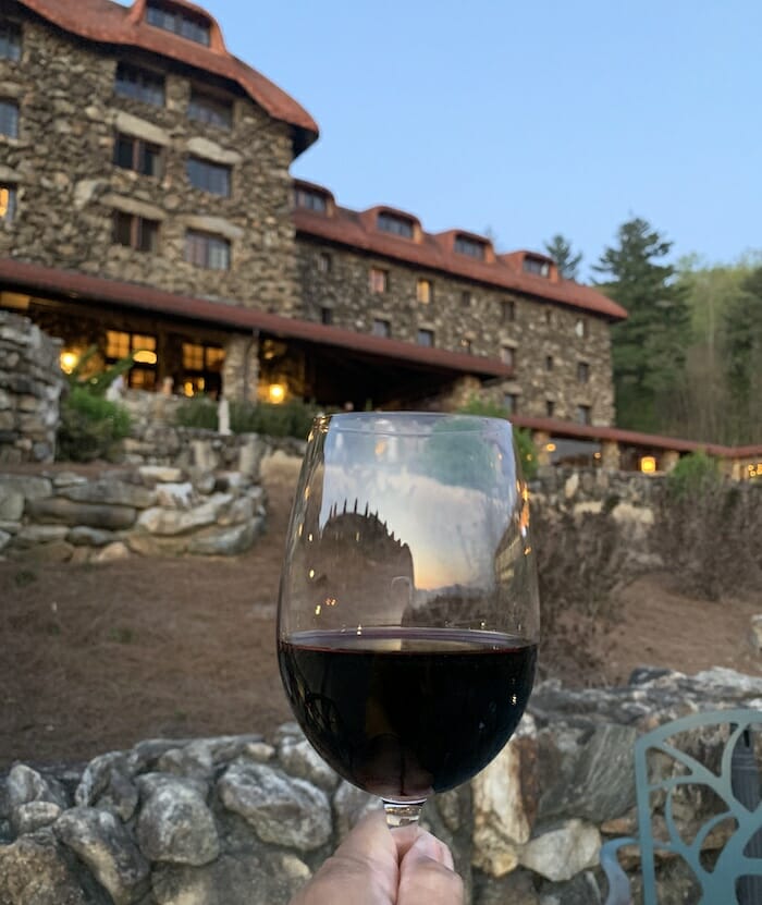 filled wine glass with The Omni Grove Park Inn in the background