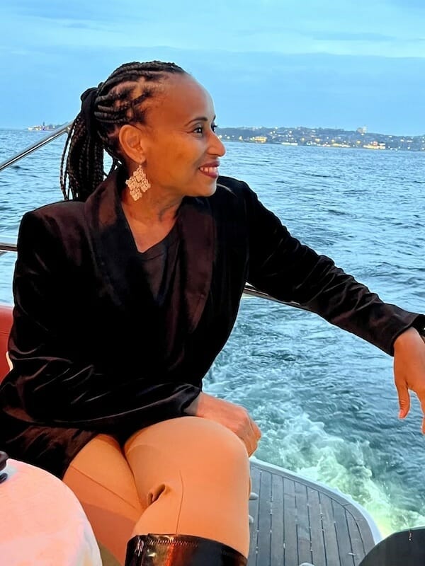 Nadeen looking over the railing on a yacht cruise