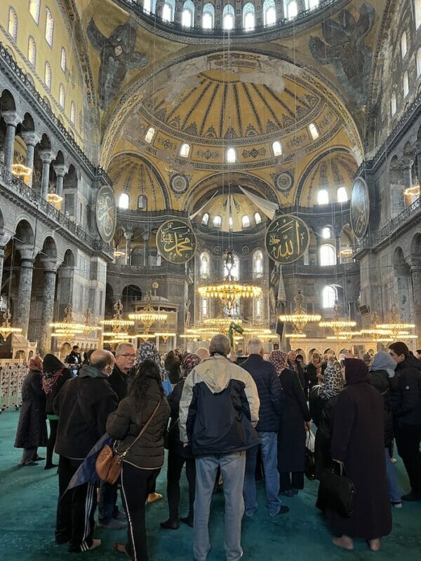 the interior of Hagia Sophia with a crowd of people inside