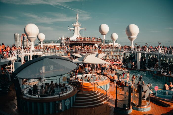 photo of cruise ship pool and deck with a large crowd